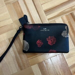 Coach wristlet with red flower detail